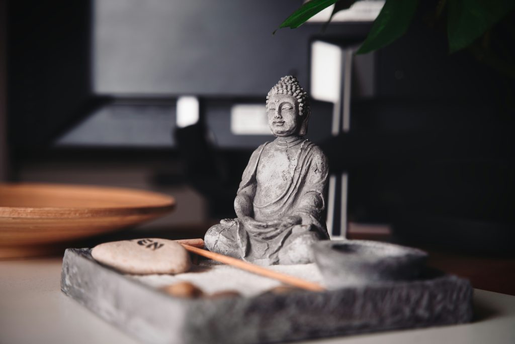 A buddha in a sandbox