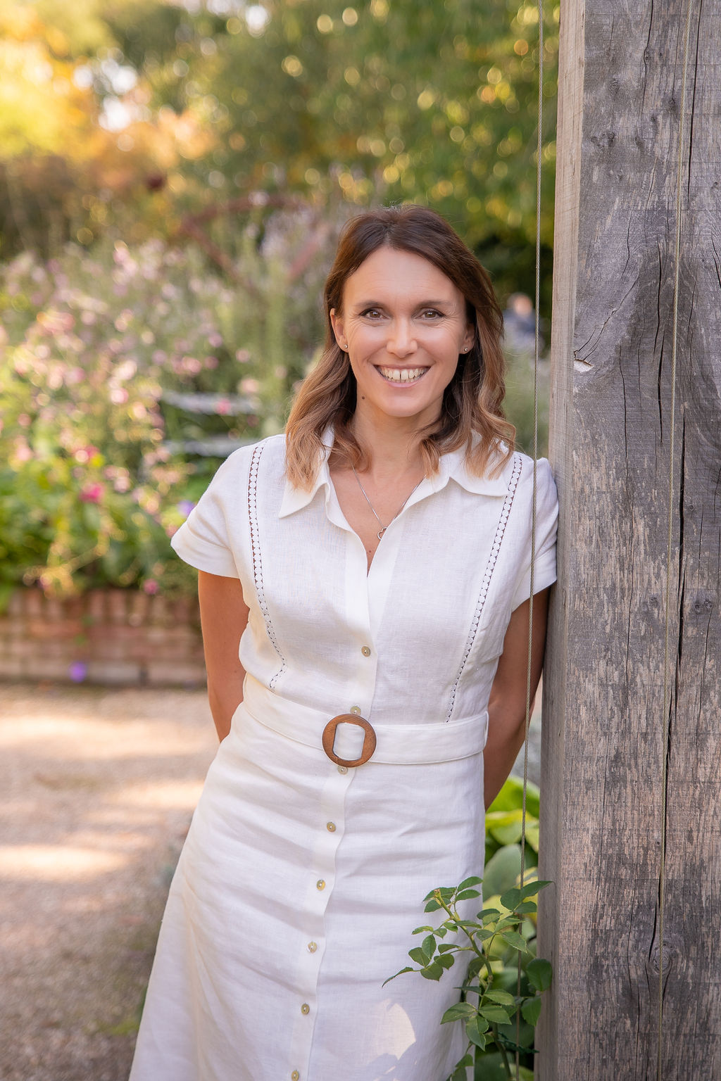 Amy_Claire_Barnes_Photography_Branding_Photoshoot_(Studio_Hummingbird)-03574 Garden Designer Victoria Rumens leaning against a wooden arbout in a stunning garden