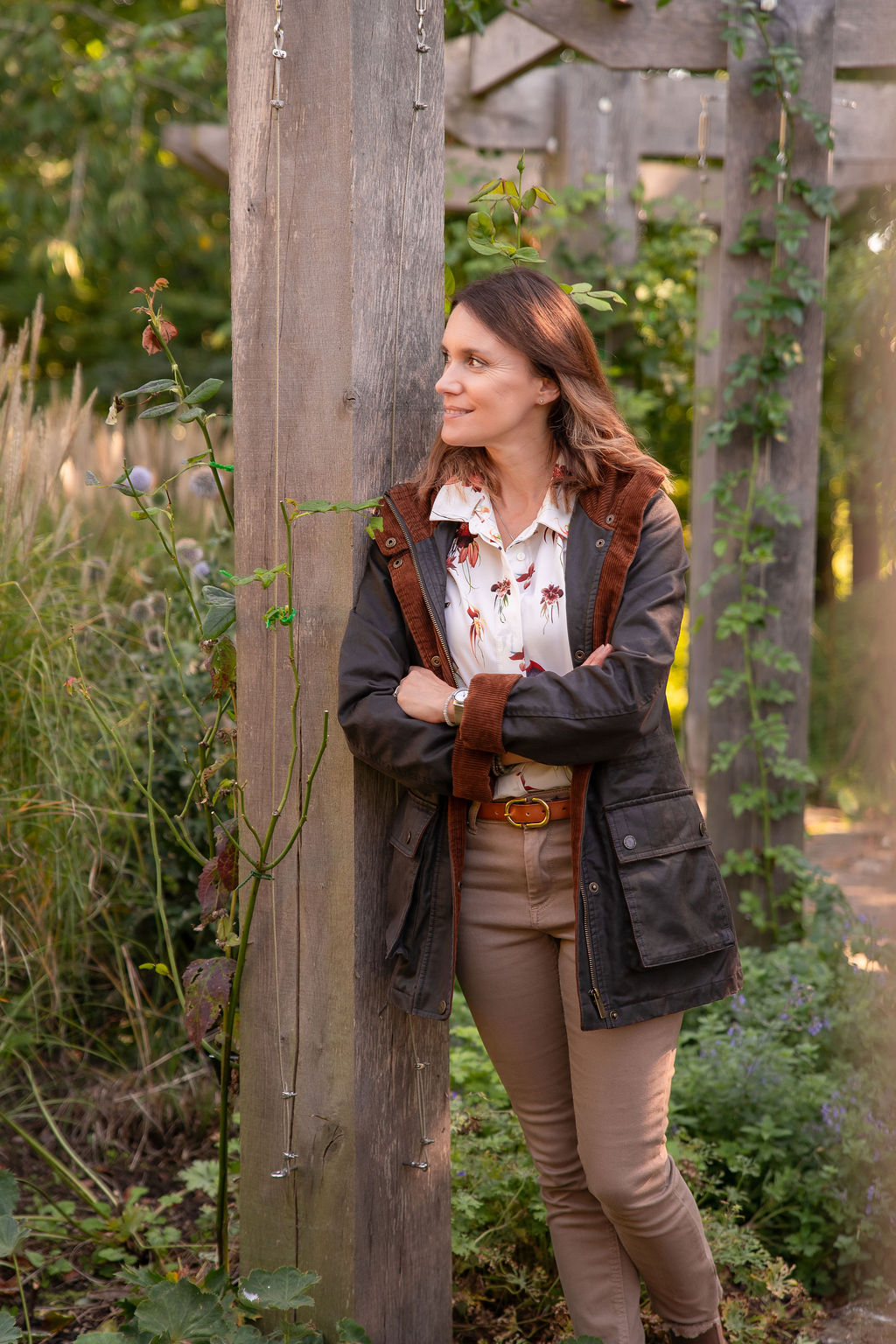Garden Design Consultation Garden Designer Victoria Rumens infront of ornamental grasses in a stunning Sussex garden.
