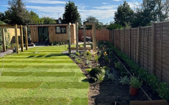 Studio Hummingbird | Garden Design Worthing Completed garden design in Sussex with new lawn and planting beds as well as wooden bench and structures for climbing plants.
